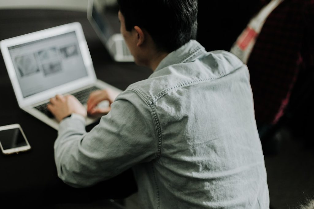 Small business owner working on a laptop, representing VPS hosting for small business
